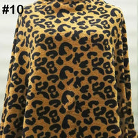 A person wears a cozy, long-sleeved top made from Longon Craft’s Printed Polar Fleece Fabric By The Yard in an ethnic leopard pattern (polyester). The number 10 is in the top left corner; the background is blurred.