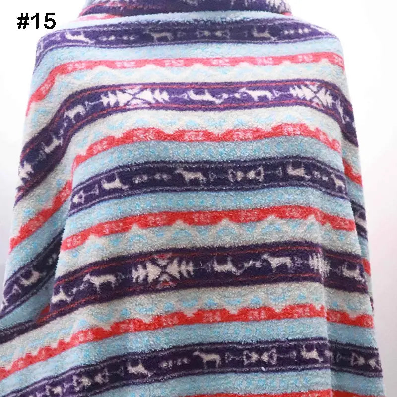 A person is wrapped in Longon Craft’s Printed Polar Fleece Fabric by the yard, featuring an ethnic leopard pattern. The soft polyester fleece is perfect for DIY crafts and sewing projects. The fabric label shows #15 in bold black text.