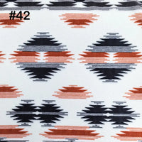 Longon Craft Printed Polar Fleece Fabric By The Yard features an ethnic leopard pattern in black and rust-orange on white, ideal for DIY crafts and sewing. #42 is noted in black at the top left, showcasing a tribal-inspired style. Polyester material.