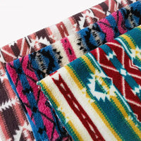 Three vibrant Longon Craft polar fleece fabrics, featuring ethnic leopard patterns in red, blue, pink, yellow, white, and black polyester, are stacked together on a white background. Perfect for DIY crafts or sewing projects.