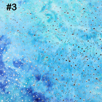 A vibrant tie-dye stars background in blue and teal from Longon Craft's Rainbow Minky Fabric, perfect for sewing plushies or showcasing baby blankets, features a number 3 in the top left for added style.