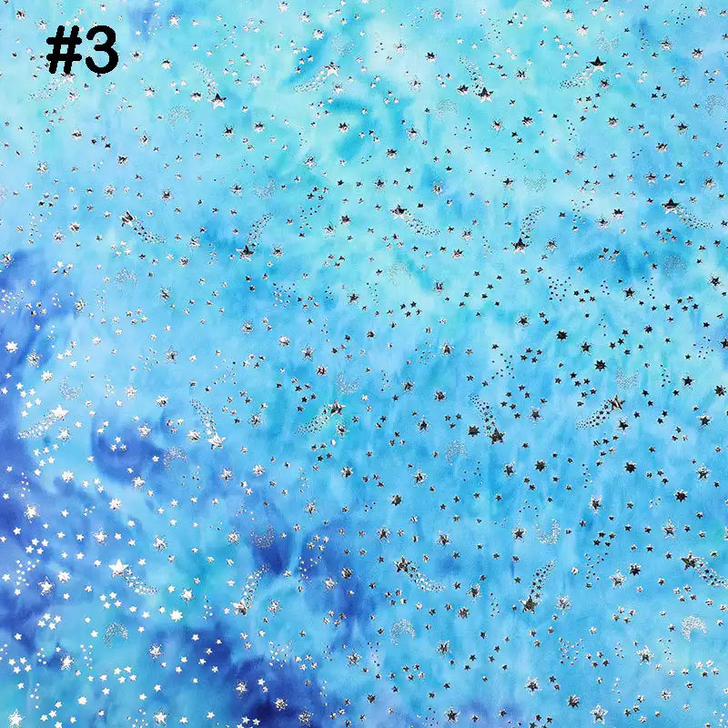 A vibrant tie-dye stars background in blue and teal from Longon Craft's Rainbow Minky Fabric, perfect for sewing plushies or showcasing baby blankets, features a number 3 in the top left for added style.