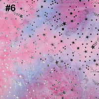 The Rainbow Minky Fabric by Longon Craft features a colorful tie-dye background with silver foil stars, moons, and comets, perfect for plushies and craft sewing. Number 6 is displayed in the top left corner.