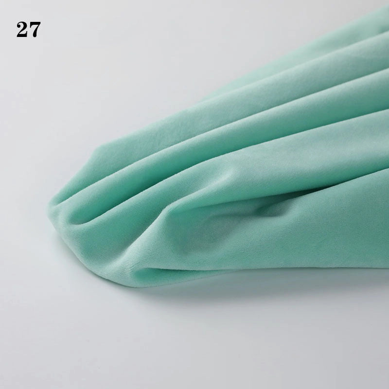 Longon Craft's Soft Minky Fabric By The Yard (1mm Minky Cuddle Doll Plushies Material) in light mint green is draped on a white surface, with the number 27 in the top left corner. Perfect for DIY sewing and craft projects.
