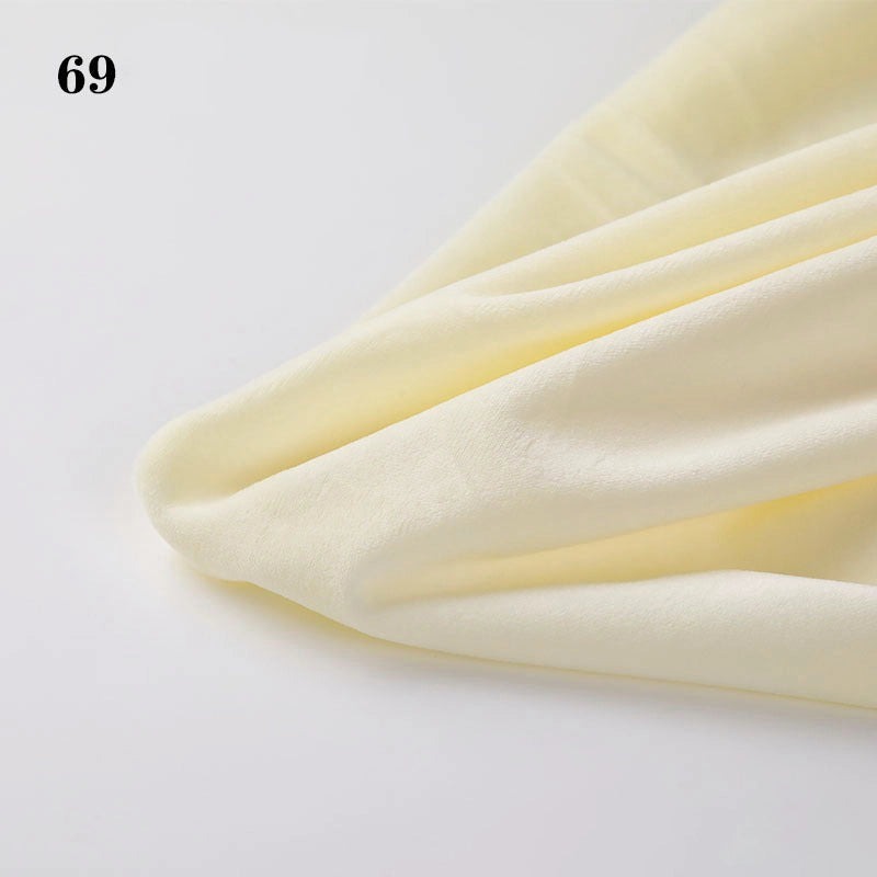 Longon Craft's Soft Minky Fabric By The Yard (1mm) with a smooth, light yellow texture is displayed on a white surface. Ideal for DIY sewing and plushies, it features the number 69 in the top left corner.