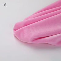 A close-up of Longon Craft’s Soft Minky Fabric By The Yard in light pink, a smooth 1mm plush material for DIY crafts and sewing, is spread on a white surface with the number 6 in the upper left corner.