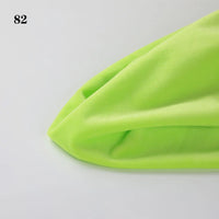 A close-up of folded Soft Minky Fabric By The Yard from Longon Craft in neon green 1mm plush material on a white surface, with the number 82 in the top left corner.