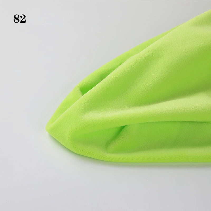 A close-up of folded Soft Minky Fabric By The Yard from Longon Craft in neon green 1mm plush material on a white surface, with the number 82 in the top left corner.