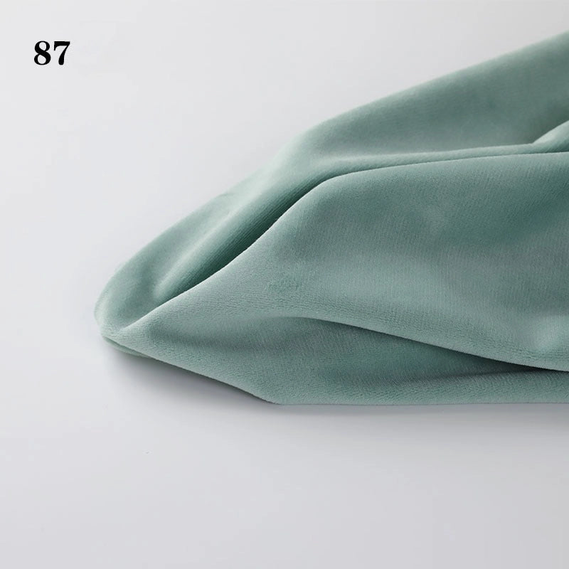 A close-up of Longon Craft Soft Minky Fabric By The Yard, 1mm plush material for DIY sewing and upholstery, in light green, neatly folded on a white surface with the number 87 in the top left corner.