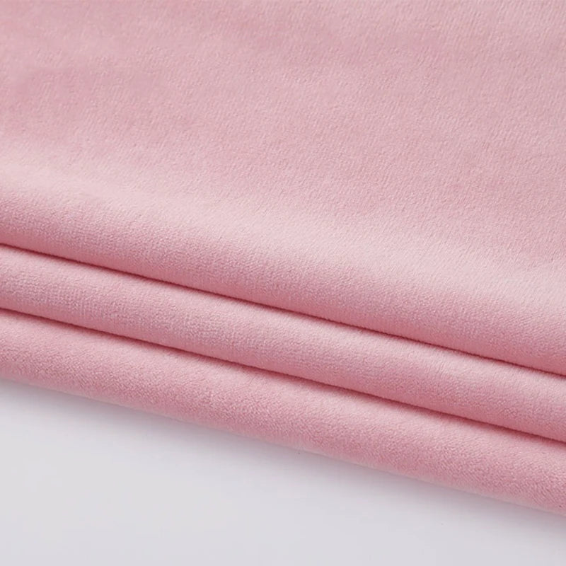 Close-up of Longon Craft Soft Minky Fabric by the Yard, a 1mm light pink plush material with a smooth texture, ideal for DIY sewing crafts and upholstery projects.