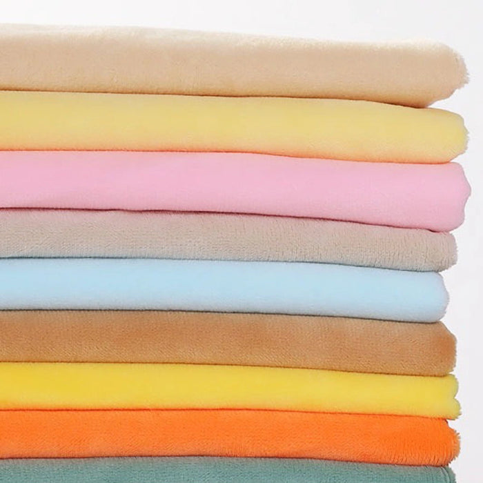A neatly stacked pile of Soft Minky Fabric By The Yard from Longon Craft, in pastel and bright shades like beige, yellow, pink, blue, and orange—ideal plush material for DIY sewing, doll plushies, crafts, and upholstery projects.
