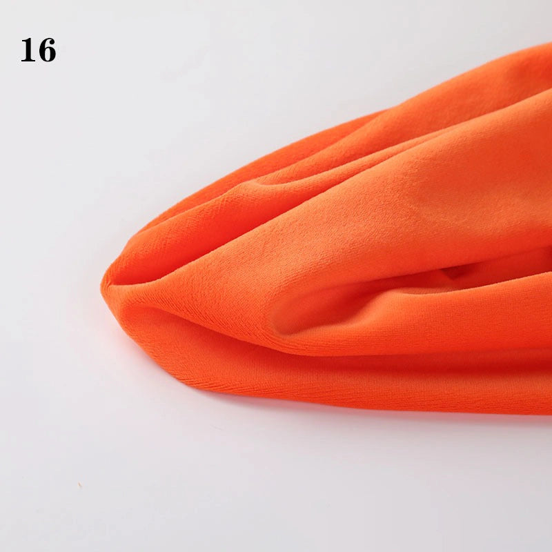 A piece of Soft Minky Fabric by the yard from Longon Craft is displayed on a white surface, bright orange in color, with "16" shown in black at the upper left. Ideal for DIY sewing and plushies.