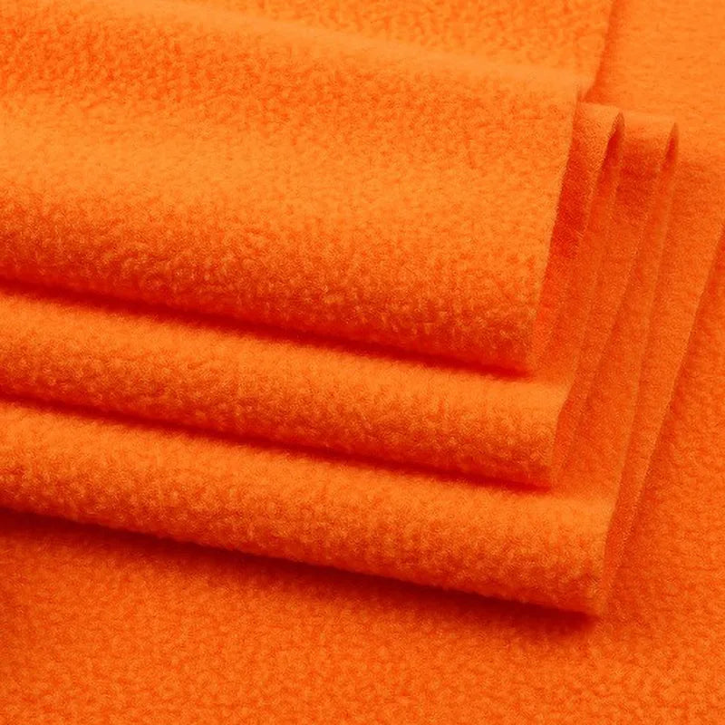 Close-up of several folded pieces of Longon Craft Solid Polar Fleece Fabric By The Yard, a thick plain 100% polyester material ideal for cozy blankets, DIY sewing, crafts, and upholstery projects.
