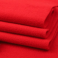 A close-up of three folded layers of bright red Longon Craft Solid Polar Fleece Fabric by the yard, made of thick 100% polyester—ideal for cozy blankets, DIY sewing, and upholstery projects.