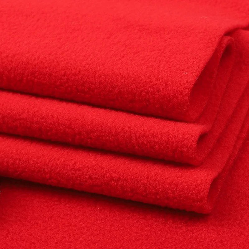 A close-up of three folded layers of bright red Longon Craft Solid Polar Fleece Fabric by the yard, made of thick 100% polyester—ideal for cozy blankets, DIY sewing, and upholstery projects.