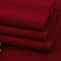 A close-up of three neatly folded pieces of Longon Craft's Solid Polar Fleece Fabric By The Yard, a thick plain 100% polyester material, stacked on red—ideal for cozy DIY sewing, crafts, or upholstery projects.