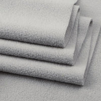 A close-up of folded Longon Craft Solid Polar Fleece Fabric By The Yard highlights its soft, thick 100% polyester texture, ideal for cozy DIY sewing, crafts, or upholstery projects.