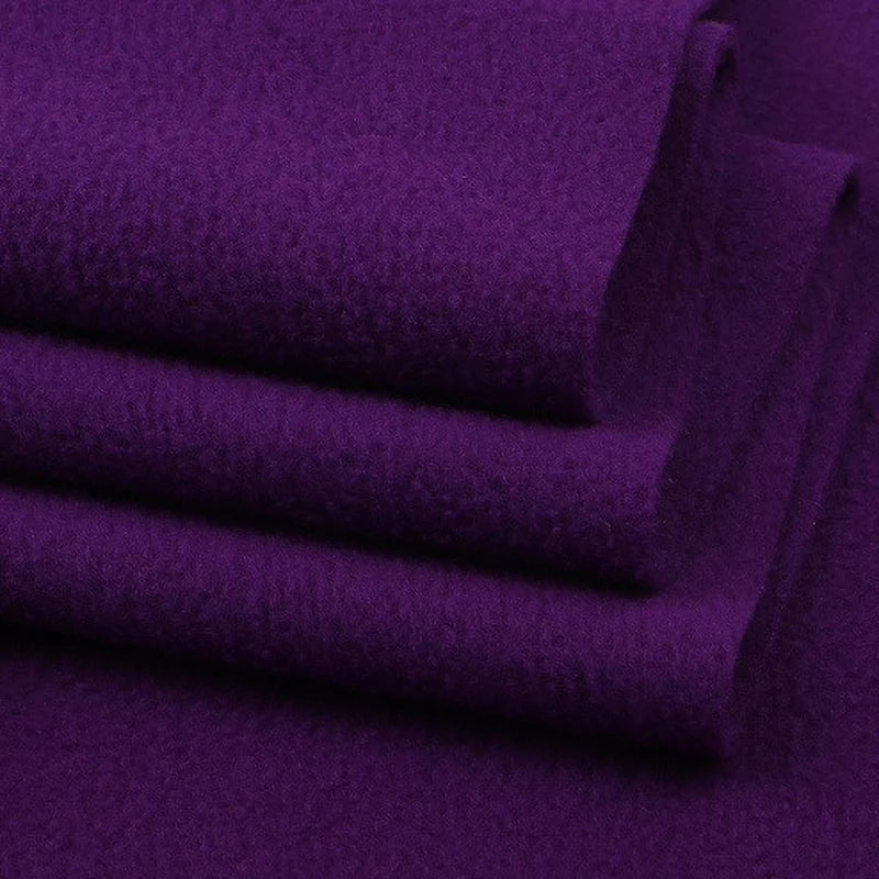 A close-up of several neatly folded pieces of Longon Craft Solid Polar Fleece Fabric By The Yard, 100% polyester and thick plain texture—ideal for DIY sewing, crafts, or cozy upholstery projects.