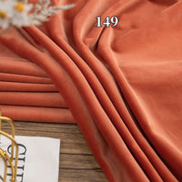 Longon Craft's Stretch Minky Fabric By The Yard, a plush multicolor four-way stretch cuddle material, is draped on wood with "149" overlaid and a magazine in the corner—perfect for DIY clothing, pillows, plushies, dolls, and blankets.