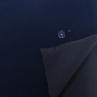 A close-up of Longon Craft Waterproof Polar Fleece Fabric By The Yard shows water beading on its surface, highlighting its water resistance. One corner is folded to reveal the soft underside of this 4-way stretch polyester fleece material.