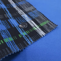 A close-up shows Longon Craft's Waterproof Polar Fleece Fabric by the Yard, featuring blue, black, green, and white patterns on solid blue. A water droplet highlights its water-repellent, 4-way stretch polyester—ideal for outdoor sewing projects.