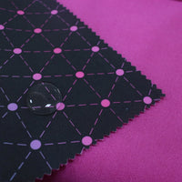 A close-up of Longon Craft’s Waterproof Polar Fleece Fabric By The Yard shows black polyester fleece with a pink geometric pattern and scalloped edges on pink cloth. A water droplet highlights its water-repellent property and 4-way stretch.