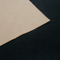 A close-up of Waterproof Polar Fleece Fabric By The Yard from Longon Craft, in brown, resting on a black surface; the 4-way stretch synthetic polyester resembles textures found in outdoor jackets.
