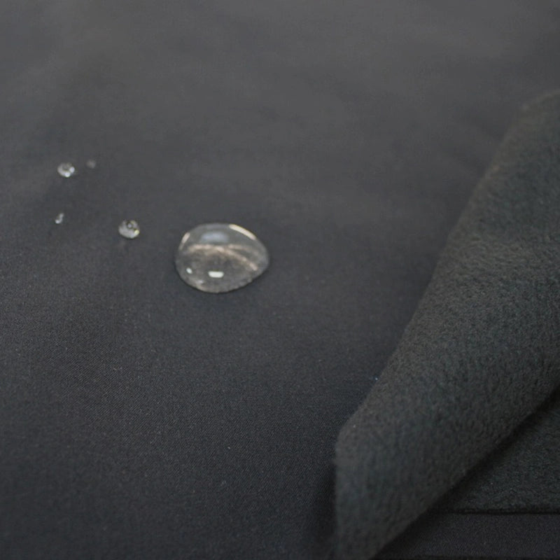 Close-up of Longon Craft Waterproof Polar Fleece Fabric By The Yard shows water droplets beading up, highlighting its water-repellent surface and soft inner texture. Ideal 4-way stretch polyester fabric for outdoor gear and crafts.
